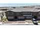 Exterior view of townhomes featuring brick driveways, garages, and well-maintained landscaping at 9605 Oliver Hills Ave, Las Vegas, NV 89143