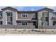 Modern townhome exterior with neutral paint, dark trim, and desert landscaping for low maintenance at 9605 Oliver Hills Ave, Las Vegas, NV 89143
