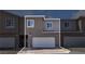 Modern townhouse featuring a two-car garage and neutral-toned stucco exterior at 9605 Oliver Hills Ave, Las Vegas, NV 89143