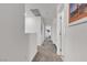 Hallway with neutral carpet featuring white walls with access to other rooms at 9605 Oliver Hills Ave, Las Vegas, NV 89143