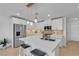 Modern kitchen with stainless steel appliances, white cabinets, and a large quartz island at 9605 Oliver Hills Ave, Las Vegas, NV 89143