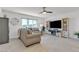 Bright living room features a ceiling fan, tile floors and lots of natural light at 9605 Oliver Hills Ave, Las Vegas, NV 89143