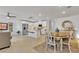 Open-concept living space with tiled floors, white cabinets, and a kitchen island with seating at 9605 Oliver Hills Ave, Las Vegas, NV 89143