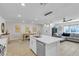 Open-concept kitchen and living area with tiled flooring and white cabinets at 9605 Oliver Hills Ave, Las Vegas, NV 89143