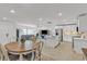 Spacious open-concept living area with tile floors, dining area, and modern kitchen at 9605 Oliver Hills Ave, Las Vegas, NV 89143