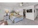 Bright bedroom features a decorative bed frame, closet and flat screen TV at 9605 Oliver Hills Ave, Las Vegas, NV 89143