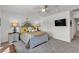 Bright bedroom features a decorative bed frame, plush bedding, and flat screen TV at 9605 Oliver Hills Ave, Las Vegas, NV 89143