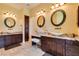 Dual sink bathroom showcasing granite counters, dark wood cabinets, and vessel sinks at 9749 Glistening Brook Ct, Las Vegas, NV 89149