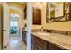 Elegant bathroom with granite counters, dark wood cabinets, and access to the bedroom at 9749 Glistening Brook Ct, Las Vegas, NV 89149