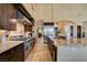 Beautiful kitchen featuring granite countertops, stainless steel appliances, and dark wood cabinetry at 9749 Glistening Brook Ct, Las Vegas, NV 89149