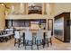 Open-concept kitchen with a large island, stainless steel refrigerator, and custom cabinetry at 9749 Glistening Brook Ct, Las Vegas, NV 89149