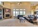 Cozy living room featuring a stone fireplace, high ceilings, and comfortable seating at 9749 Glistening Brook Ct, Las Vegas, NV 89149