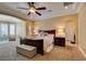 Spacious main bedroom featuring a cozy sitting area, tray ceiling, and neutral decor at 9749 Glistening Brook Ct, Las Vegas, NV 89149