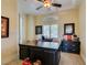 Well-lit home office featuring built-in shelving, a large desk, and plantation shutters at 9749 Glistening Brook Ct, Las Vegas, NV 89149