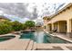Beautiful backyard pool with water features, a spa, and easy access to the home's outdoor living spaces at 9749 Glistening Brook Ct, Las Vegas, NV 89149
