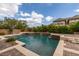 Backyard swimming pool complete with water features, raised spa, and patio area perfect for entertaining at 9749 Glistening Brook Ct, Las Vegas, NV 89149