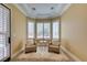 Cozy sitting area featuring large windows with plantation shutters and comfortable armchairs at 9749 Glistening Brook Ct, Las Vegas, NV 89149