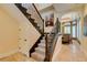 Elegant staircase features detailed iron work, leading into the dining area and hallway at 9749 Glistening Brook Ct, Las Vegas, NV 89149