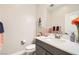 Cozy powder room featuring fresh flowers, stylish fixtures, and a modern vanity at 9765 Skye Star Ave, Las Vegas, NV 89166
