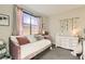 Bright bedroom with a daybed, soft pink accents, and a decorative floral arrangement at 9765 Skye Star Ave, Las Vegas, NV 89166