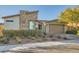 Stylish single-story home with stone accents, a two-car garage, and tidy landscaping at 9765 Skye Star Ave, Las Vegas, NV 89166