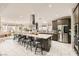 Modern, spacious kitchen featuring a large island with seating, stainless steel appliances, and lots of natural light at 9765 Skye Star Ave, Las Vegas, NV 89166