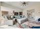 Open-concept living room with a large sectional, comfortable seating, and view of the kitchen area at 9765 Skye Star Ave, Las Vegas, NV 89166