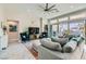 Bright living room featuring a large sectional sofa, stylish decor, and sliding glass doors at 9765 Skye Star Ave, Las Vegas, NV 89166