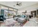 Spacious living room with a large sectional sofa, open to the kitchen, and access to outdoor patio at 9765 Skye Star Ave, Las Vegas, NV 89166