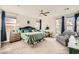 Cozy main bedroom featuring a ceiling fan, plush carpeting, and ample natural light at 9765 Skye Star Ave, Las Vegas, NV 89166