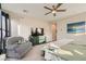 Spacious main bedroom features a ceiling fan and comfortable seating area, offering a relaxing retreat at 9765 Skye Star Ave, Las Vegas, NV 89166