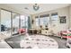 Bright and inviting playroom with large windows and sliding doors, featuring a round rug and plenty of space at 9765 Skye Star Ave, Las Vegas, NV 89166