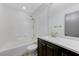 Bright bathroom with tub and shower combination, vanity, and neutral tones at 10078 Delicate Dew St, Las Vegas, NV 89183