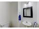 Bathroom with a pedestal sink, a blue towel, decorative lighting, and a toilet at 10078 Delicate Dew St, Las Vegas, NV 89183