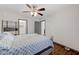 Bedroom featuring a ceiling fan, hardwood flooring, and neutral colored paint at 10078 Delicate Dew St, Las Vegas, NV 89183