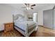Bedroom featuring a ceiling fan, hardwood flooring, and neutral colored paint at 10078 Delicate Dew St, Las Vegas, NV 89183