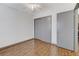 Bedroom featuring hardwood floors, closet with sliding doors, and neutral walls, providing storage at 10078 Delicate Dew St, Las Vegas, NV 89183