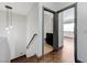 Hallway with hardwood floors, stylish lighting, and access to the bathroom and bedroom at 10078 Delicate Dew St, Las Vegas, NV 89183