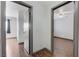 Hallway with hardwood floors, two doorways, and access to bedroom with ceiling fan at 10078 Delicate Dew St, Las Vegas, NV 89183