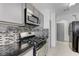 Modern kitchen featuring stainless steel appliances, gas range, and gray cabinets with sleek hardware at 10078 Delicate Dew St, Las Vegas, NV 89183