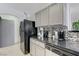 Well-lit kitchen with black appliances, mosaic backsplash, and countertops with plenty of workspace at 10078 Delicate Dew St, Las Vegas, NV 89183