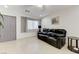 Inviting living room with ceramic tile, a modern sofa and a large window at 10078 Delicate Dew St, Las Vegas, NV 89183