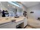 Bright bathroom featuring a soaking tub, shower, double sinks and modern countertops at 10342 Adrianna Ave, Las Vegas, NV 89129