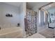 Bright bathroom with a soaking tub, decorative shower curtain, and modern countertops at 10342 Adrianna Ave, Las Vegas, NV 89129