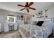 Spacious bedroom with a ceiling fan, carpet, and a vanity with a lighted mirror at 10342 Adrianna Ave, Las Vegas, NV 89129