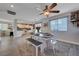 Open dining area with seating for six, modern decor, and view of bright kitchen area at 10342 Adrianna Ave, Las Vegas, NV 89129