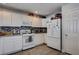 Bright, modern kitchen with white appliances, white cabinets, granite counters and mosaic backsplash at 10342 Adrianna Ave, Las Vegas, NV 89129