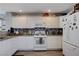 Well-lit kitchen featuring granite countertops, stainless steel appliances, and a mosaic backsplash at 10342 Adrianna Ave, Las Vegas, NV 89129