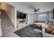 Comfortable living room features modern decor, stairs and large window for lots of natural light at 10342 Adrianna Ave, Las Vegas, NV 89129