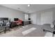 Spacious office with multiple desks, a large chair, a futon, and two windows for plenty of natural light at 10342 Adrianna Ave, Las Vegas, NV 89129